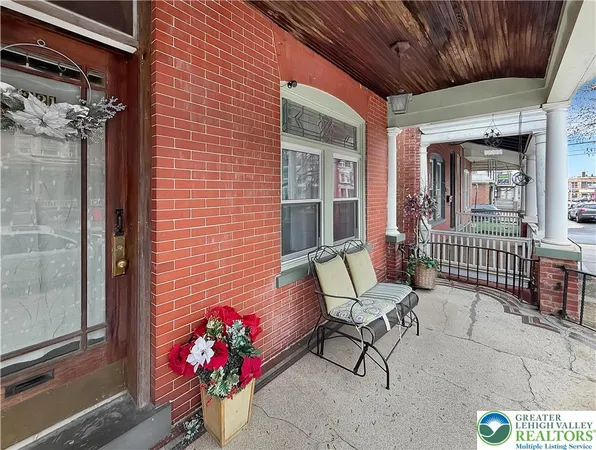 a view of a porch with a table and chairs