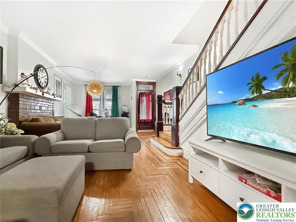 a living room with furniture and a flat screen tv