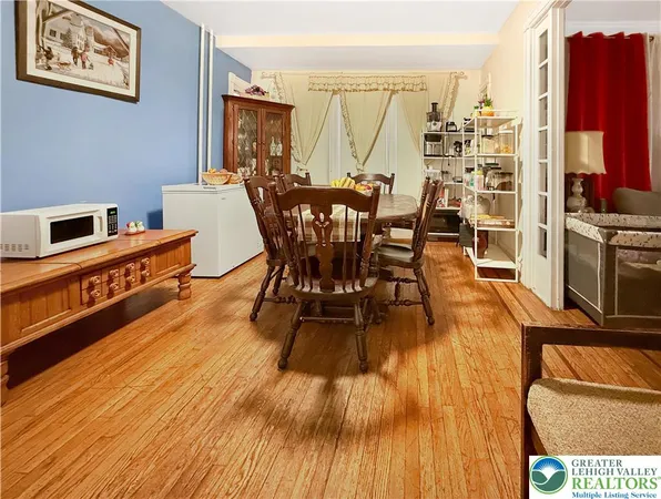 a view of a dining room with furniture window and wooden floor
