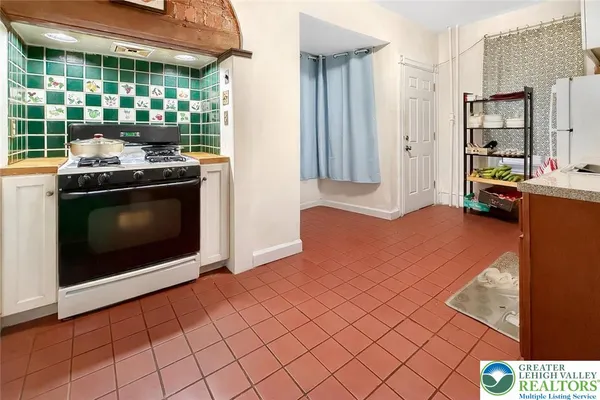 a kitchen with stainless steel appliances granite countertop a stove a microwave and a refrigerator