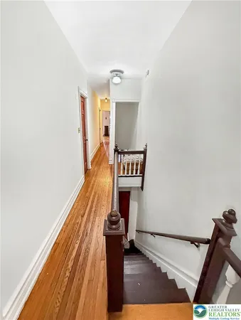 a view of a hall with wooden floor