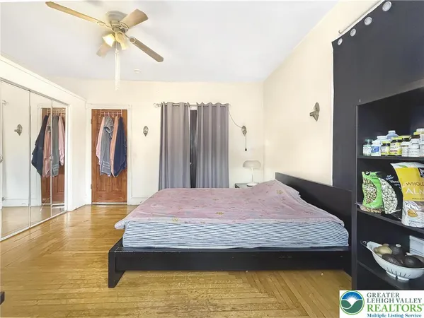 a bedroom with a bed dresser and a dining table