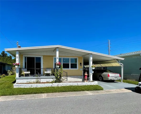 a front view of a house with a yard and porch