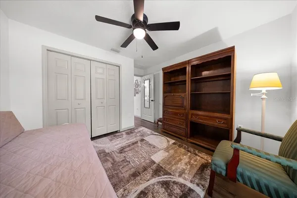 a bedroom with a bed and a television