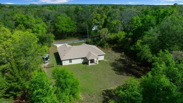 a view of house with backyard and garden