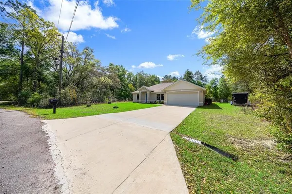 a view of a house with a yard