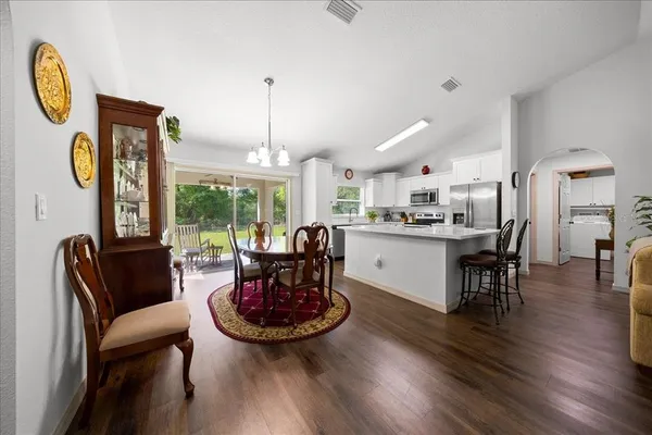 a living room with dining room and wooden floor