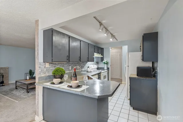 a kitchen with a sink and refrigerator