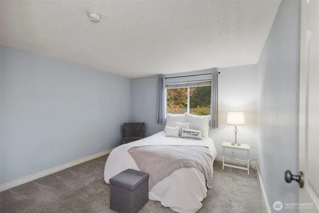 a bedroom with a bed and a lamp