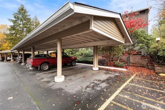 an aerial view of residential house with outdoor space and trees all around