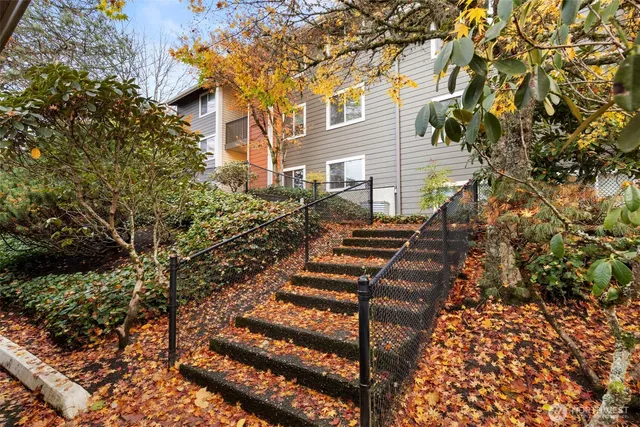 a view of stairs and yard with wooden fence