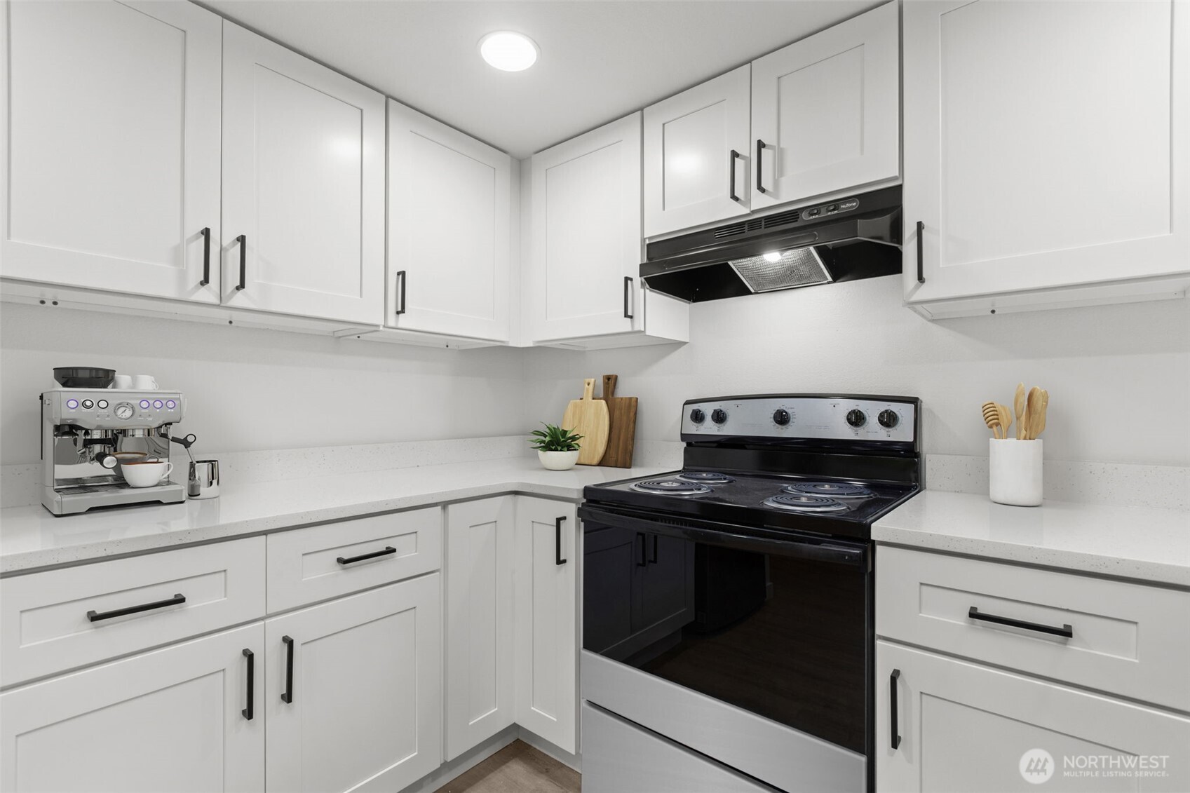 138 Southwest 116th Street, Unit G15 Seattle, WA 98146 - Photo 8 of 21 a kitchen with white cabinets and appliances