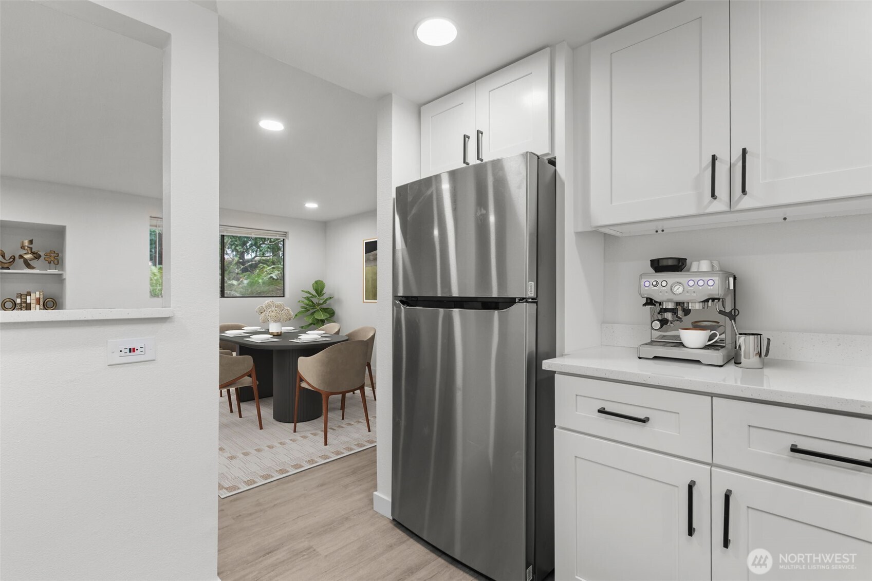 138 Southwest 116th Street, Unit G15 Seattle, WA 98146 - Photo 9 of 21 a kitchen with a refrigerator and cabinets