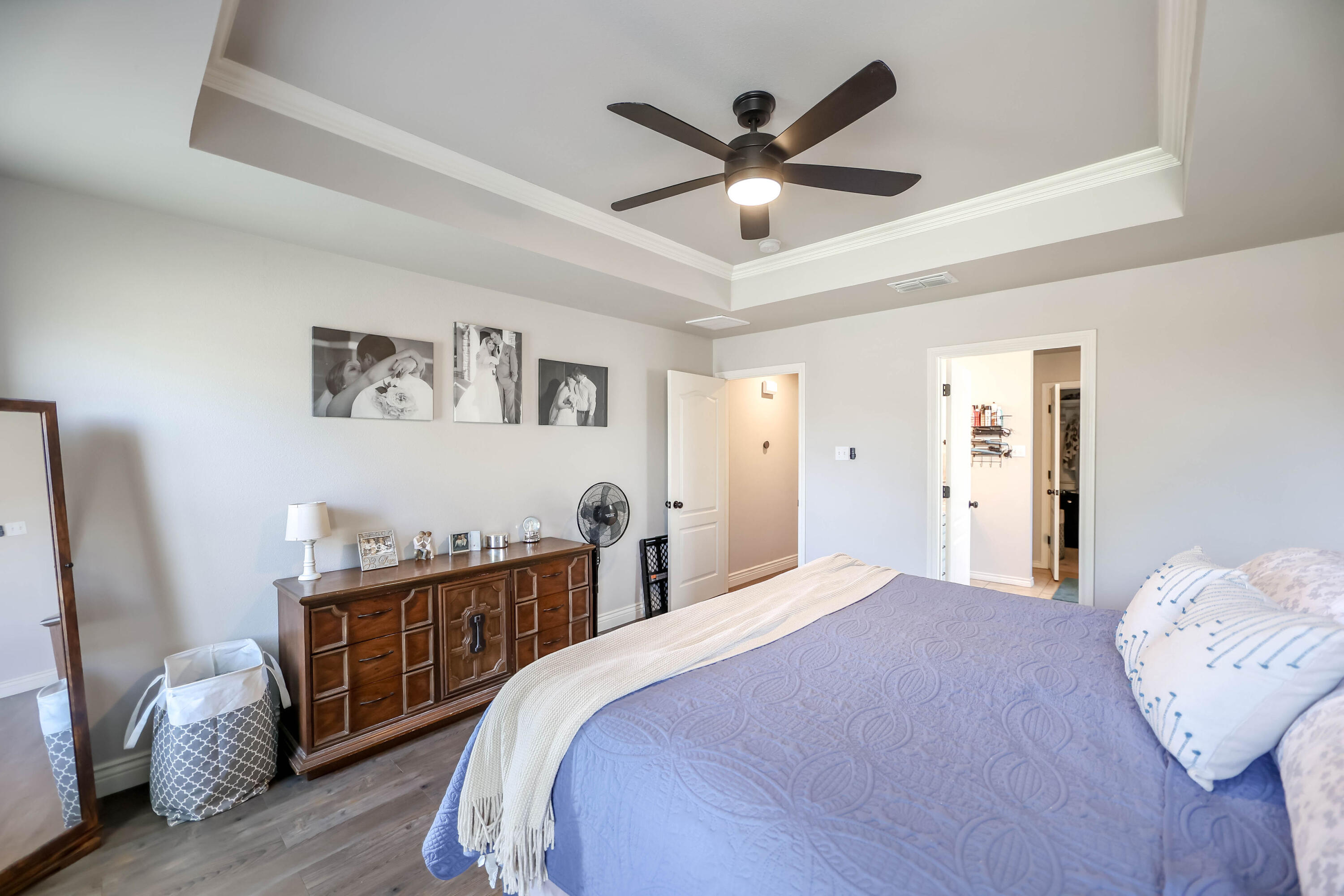 6008 103rd Street Lubbock, TX 79424 - Photo 13 of 29 a bedroom with a bed and wooden floor