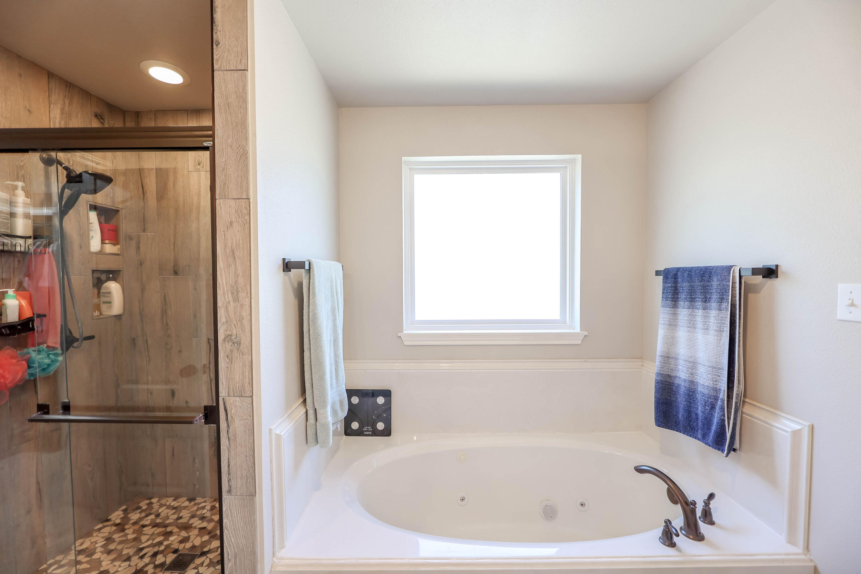 6008 103rd Street Lubbock, TX 79424 - Photo 15 of 29 a bathroom with a tub and shower