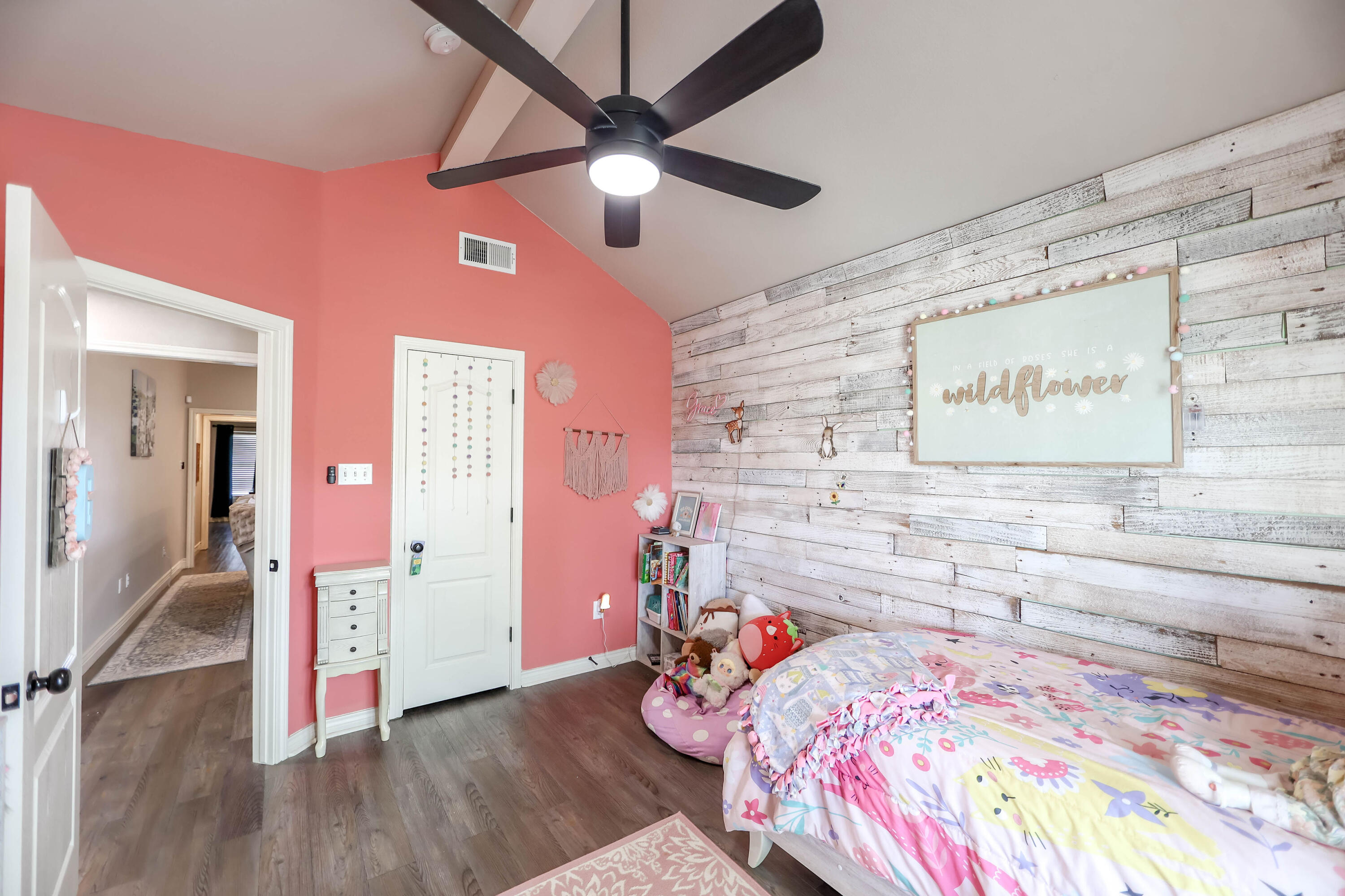 6008 103rd Street Lubbock, TX 79424 - Photo 18 of 29 a bedroom with a bed and a chandelier