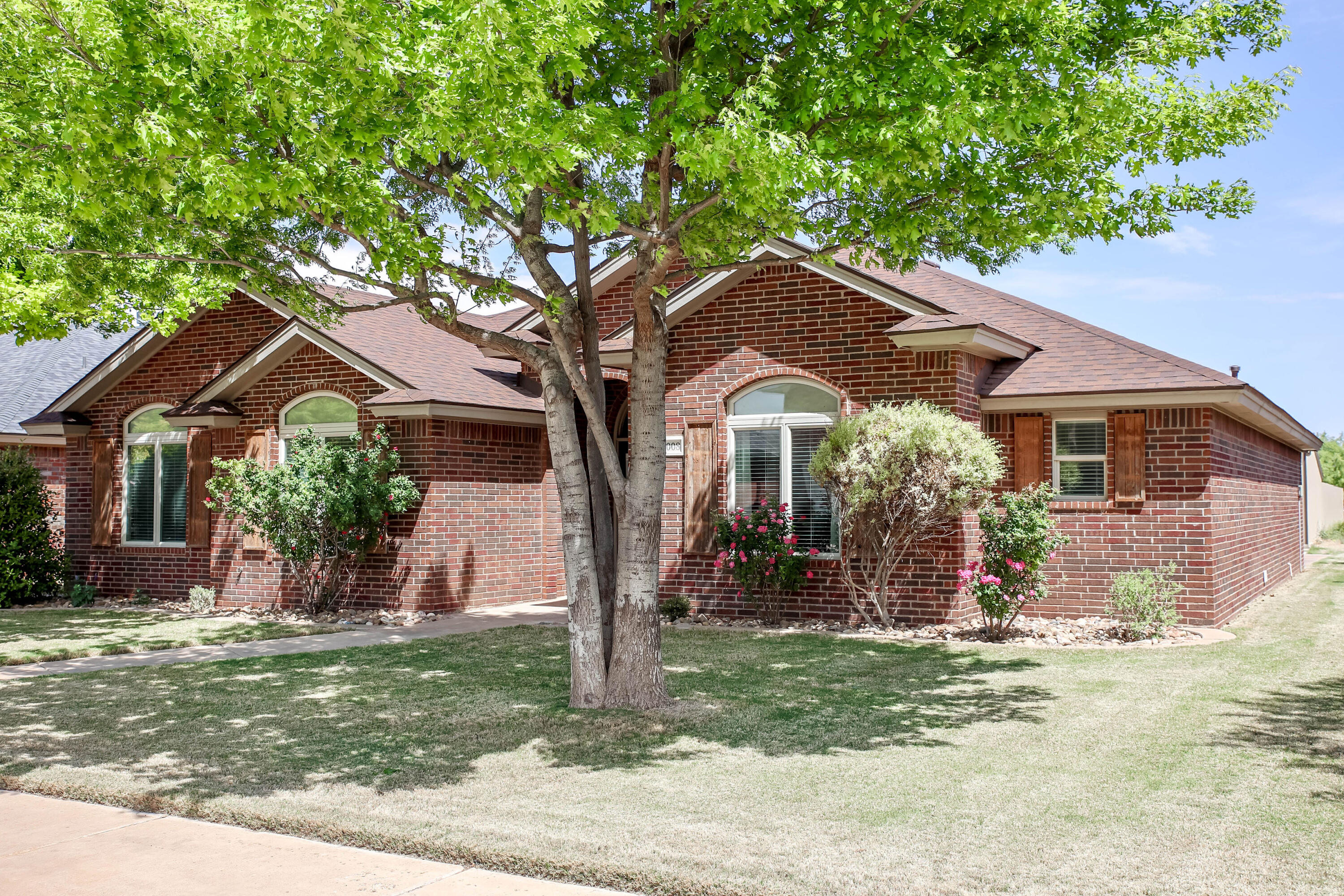 6008 103rd Street Lubbock, TX 79424 - Photo 2 of 29 a front view of a house with garden