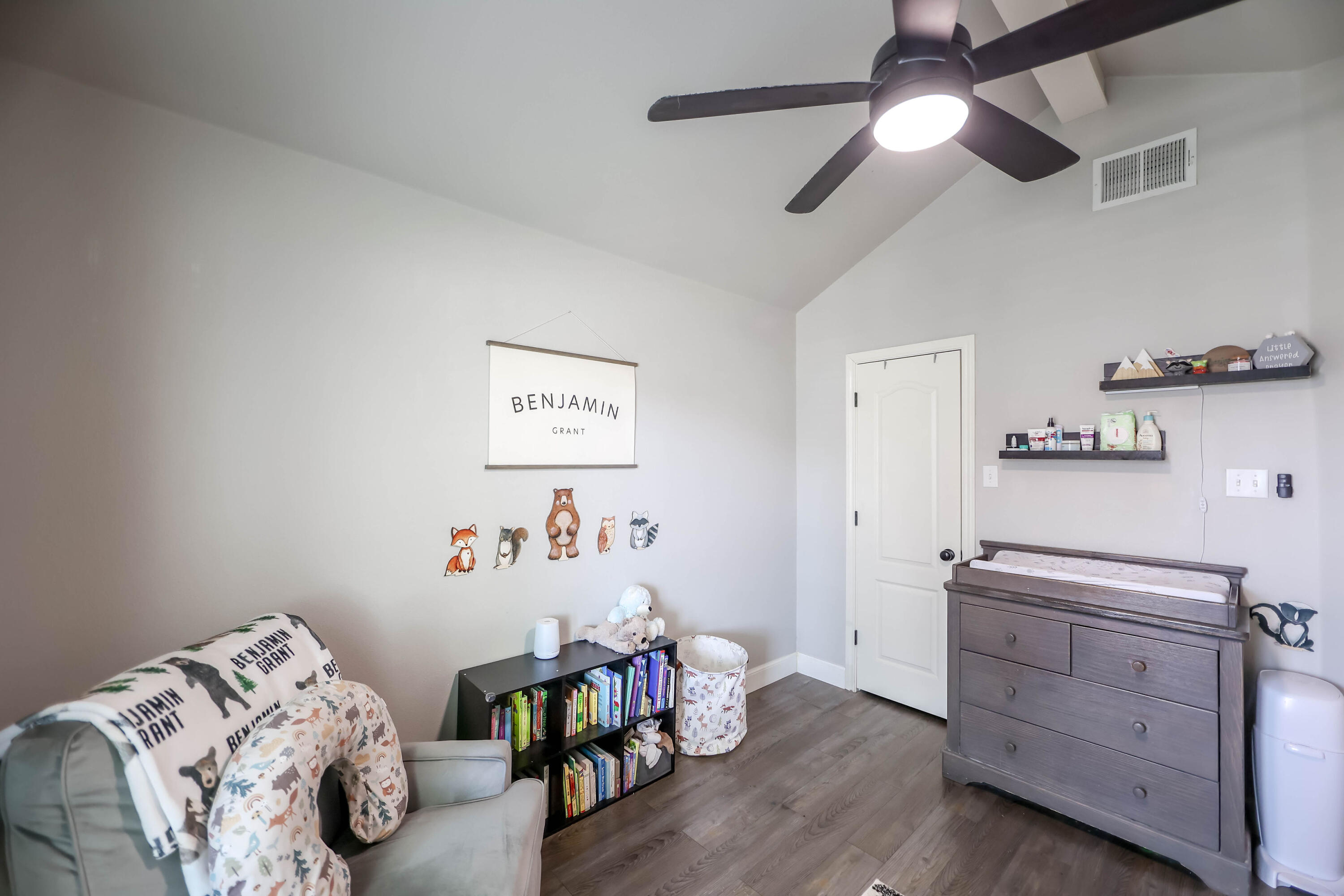 6008 103rd Street Lubbock, TX 79424 - Photo 21 of 29 a bedroom with furniture and a wooden floor