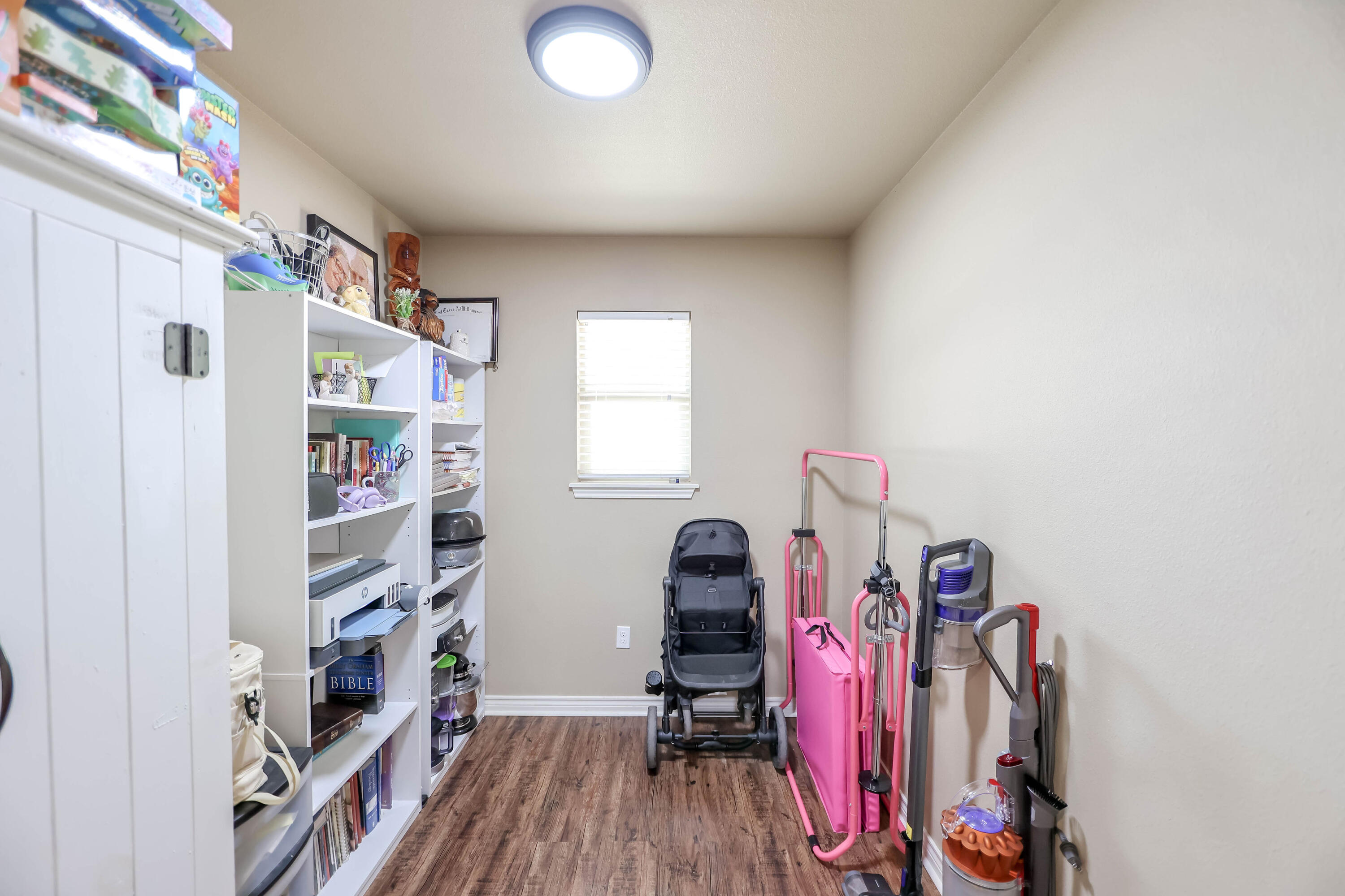 6008 103rd Street Lubbock, TX 79424 - Photo 26 of 29 a view of walk in closet with clothes and shoes