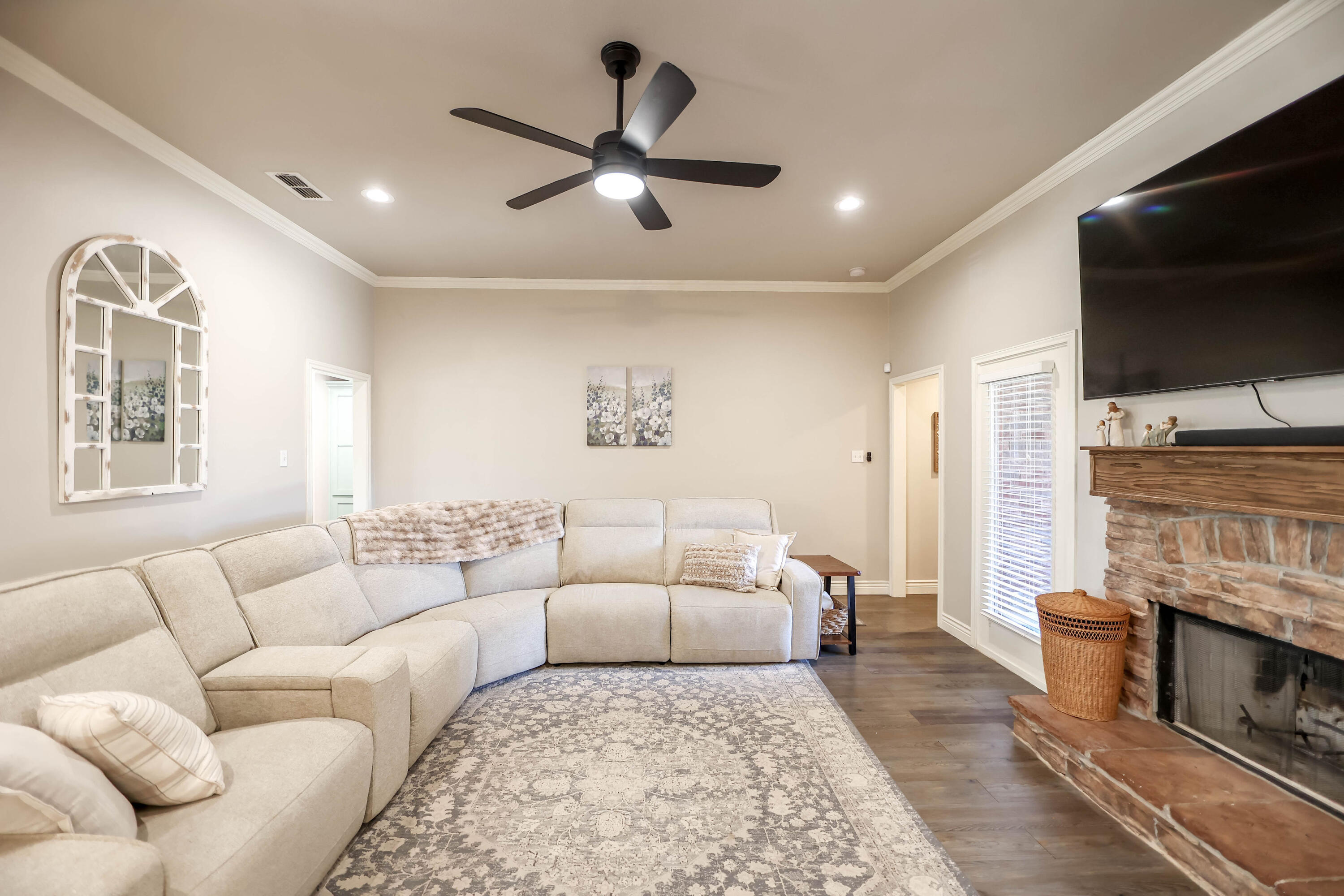 6008 103rd Street Lubbock, TX 79424 - Photo 4 of 29 a living room with furniture a flat screen tv and a fireplace