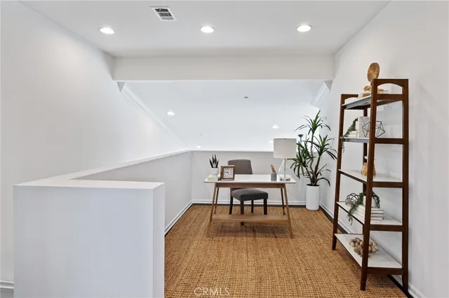 a view of a room with furniture and wooden floor