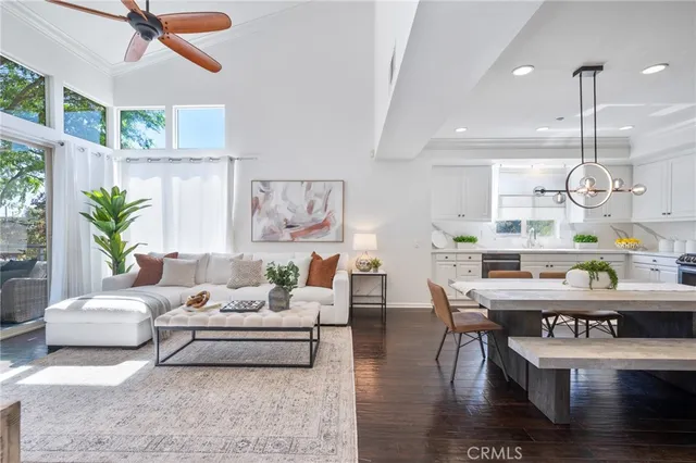 a living room with furniture wooden floor and chandelier