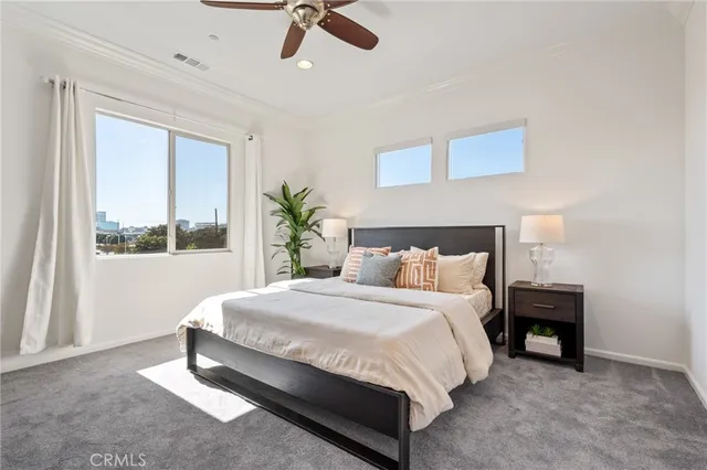 a spacious bedroom with a bed and a window