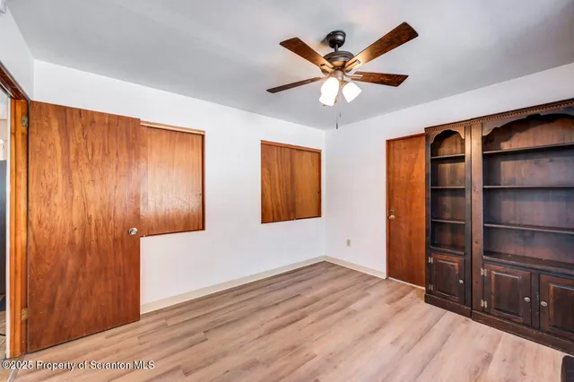 a view of a house with a yard covered in snow