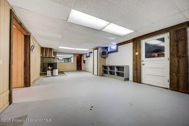 a front view of a building with large trees