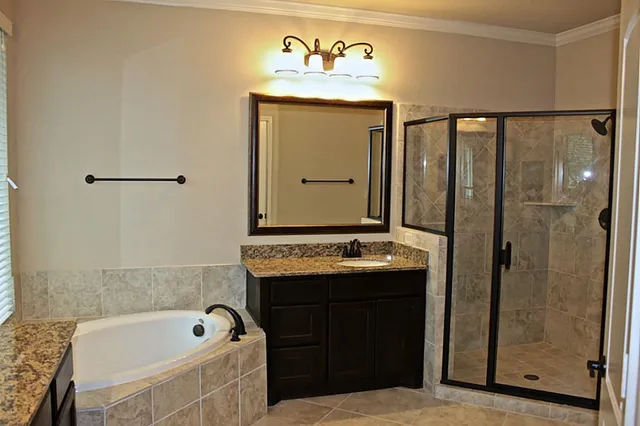 a bathroom with a tub sink and mirror