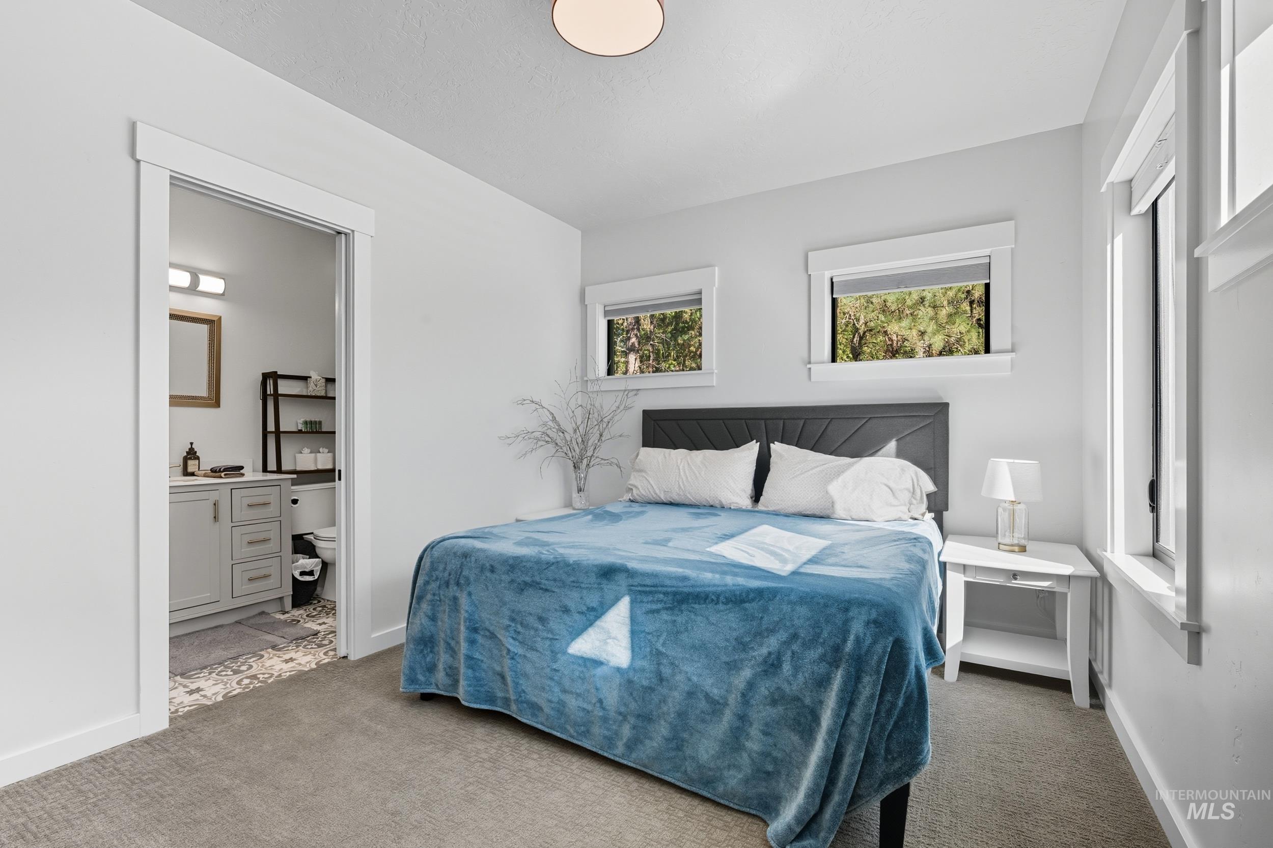 24 Rainbow Ridge Road Garden Valley, ID 83622 - Photo 12 of 32 Carpeted bedroom featuring baseboards and ensuite bathroom