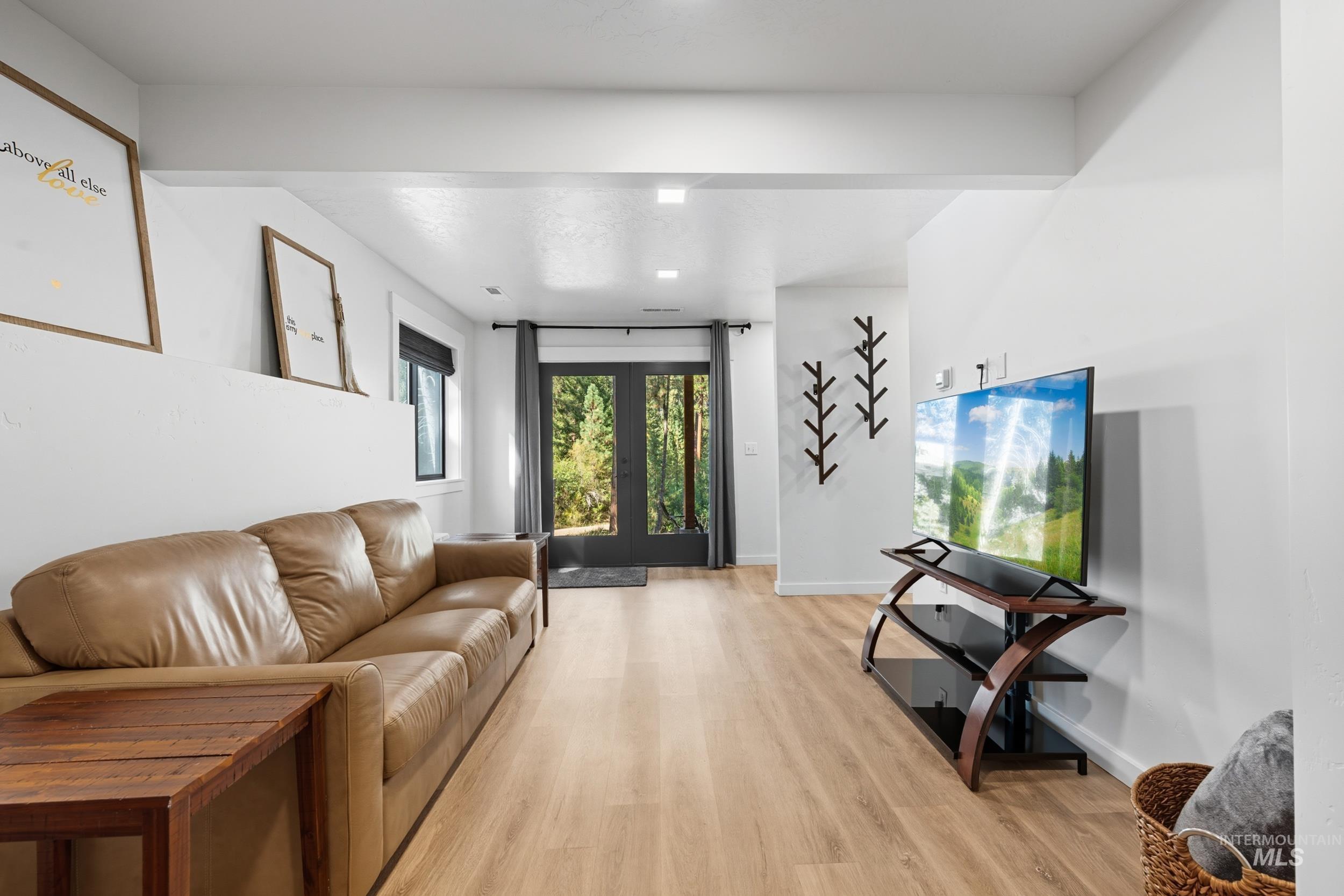 24 Rainbow Ridge Road Garden Valley, ID 83622 - Photo 16 of 32 Living area featuring light wood finished floors and french doors