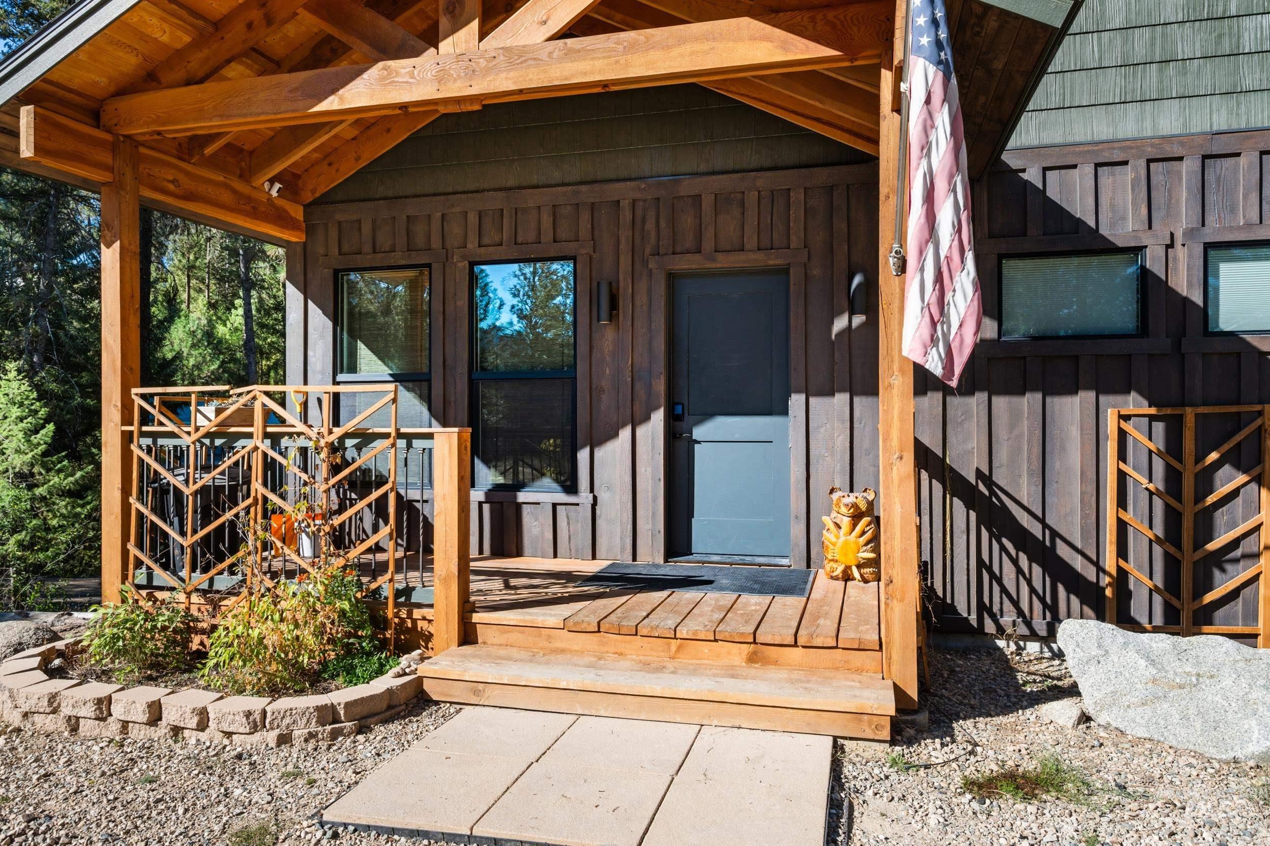 24 Rainbow Ridge Road Garden Valley, ID 83622 - Photo 2 of 32 Entrance to property with board and batten siding and a wooden deck