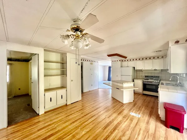 a open kitchen with stainless steel appliances a dining table chairs stove and kitchen view