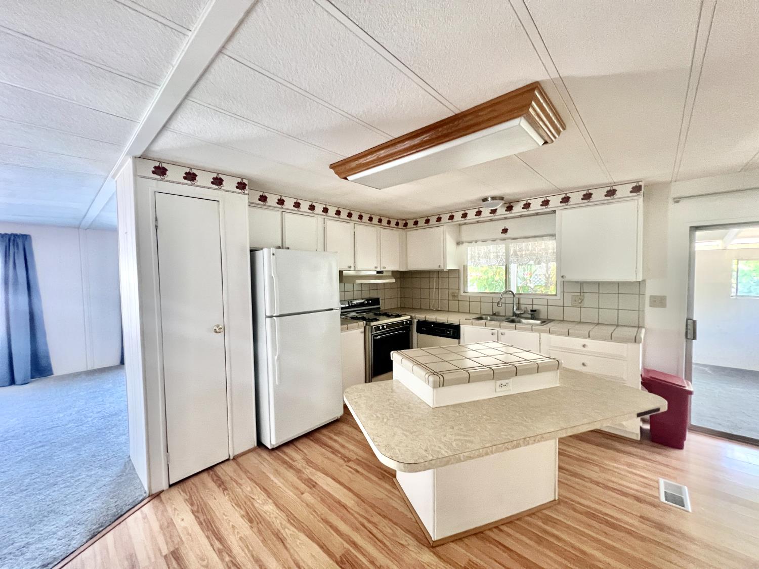 167 Rimma Way Roseville, CA 95661 - Photo 3 of 22 a kitchen with sink refrigerator and cabinets