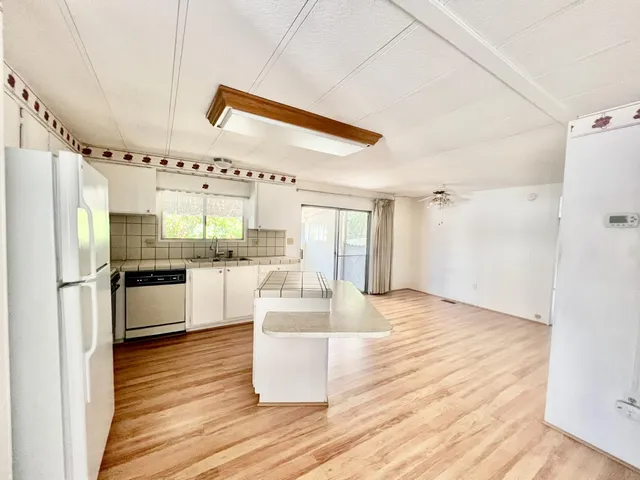 a kitchen with granite countertop a refrigerator and a stove
