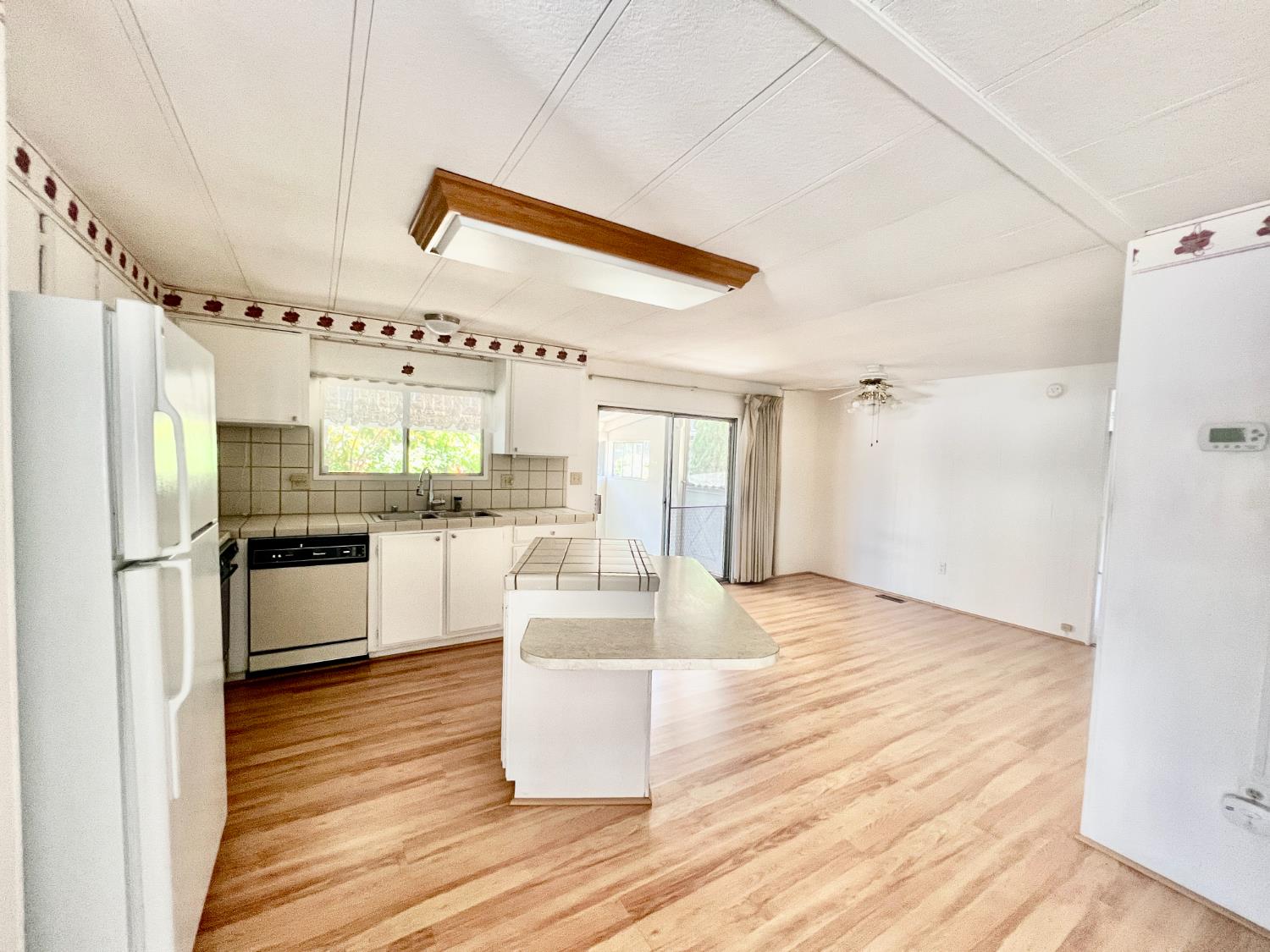 167 Rimma Way Roseville, CA 95661 - Photo 4 of 22 a kitchen with granite countertop a refrigerator and a stove