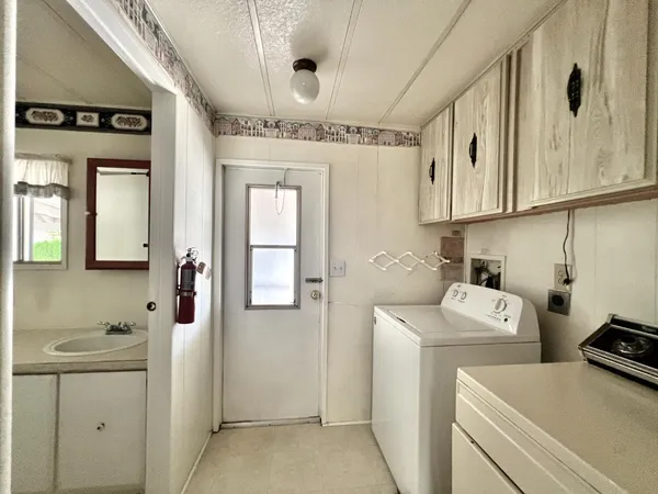 a utility room with closet dryer and washer