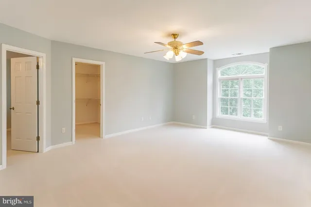 a spacious bathroom with a double vanity sink mirror and toilet