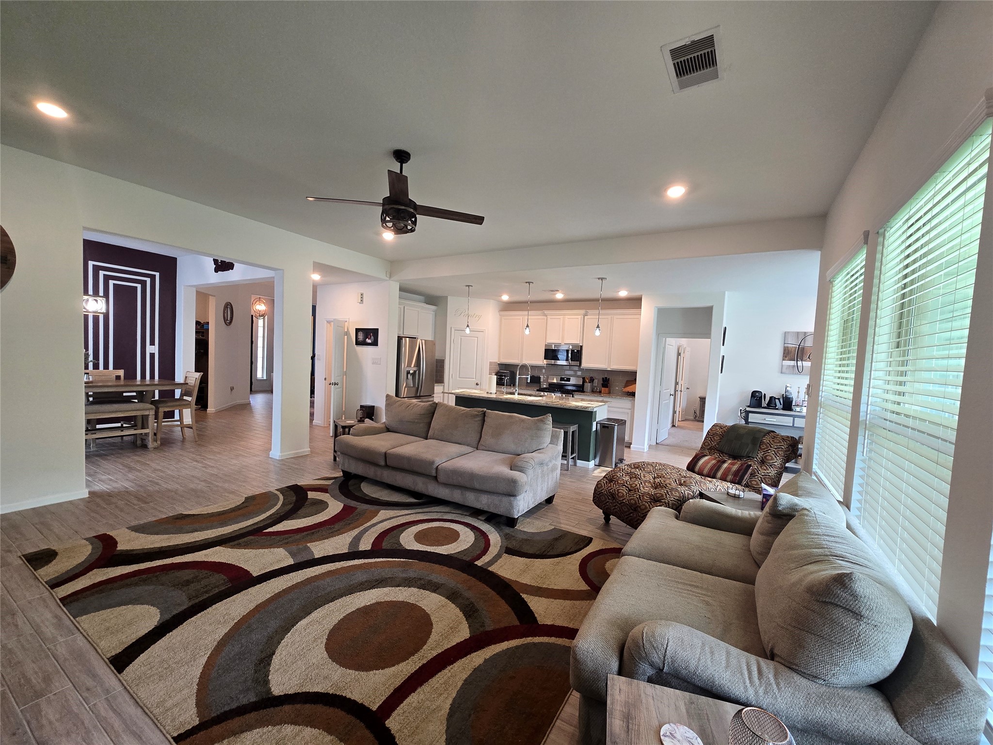 5035 Sierra Ridge Drive Rosenberg, TX 77469 - Photo 6 of 26 This inviting family room seamlessly overlooks the modern kitchen, creating an open-concept space perfect for entertaining and everyday living.