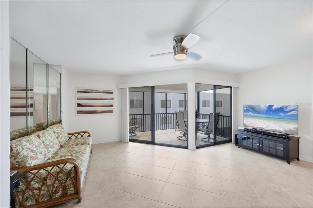 2810 North Beach Road, Unit D205 Englewood, FL 34223 - Photo 14 of 48 a living room with furniture and a flat screen tv