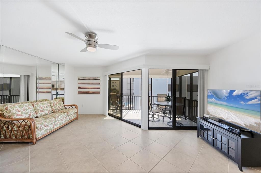 2810 North Beach Road, Unit D205 Englewood, FL 34223 - Photo 15 of 48 a spacious bedroom with a bed a couch and dresser