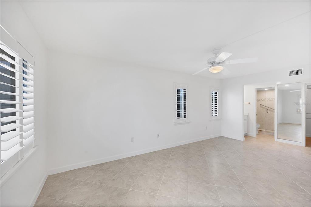 2810 North Beach Road, Unit D205 Englewood, FL 34223 - Photo 20 of 48 an empty room with windows and closet