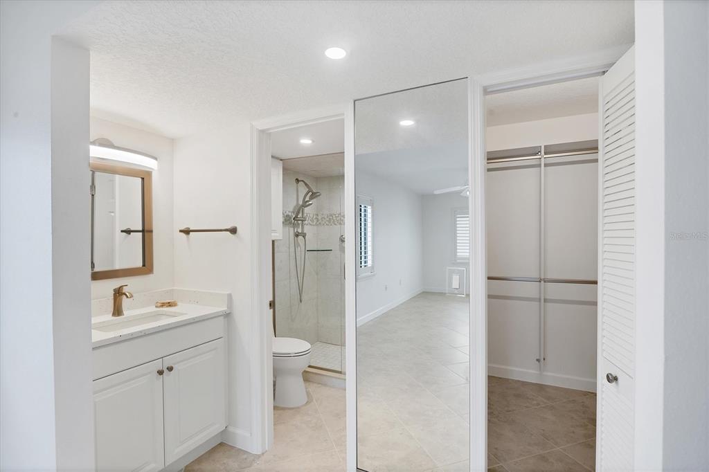2810 North Beach Road, Unit D205 Englewood, FL 34223 - Photo 23 of 48 a spacious bathroom with a shower sink mirror and toilet