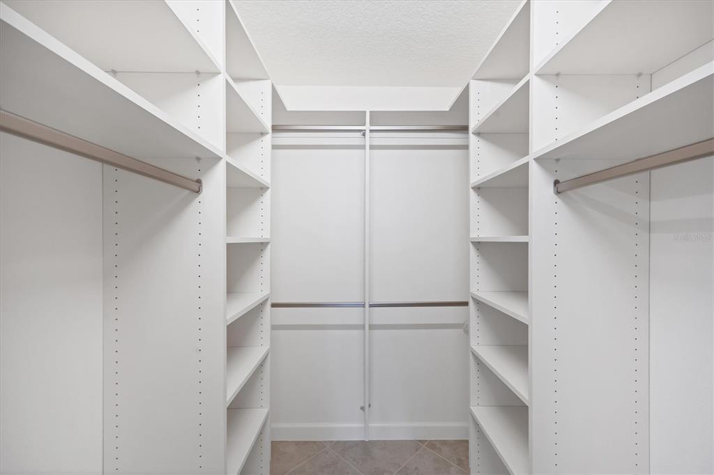 2810 North Beach Road, Unit D205 Englewood, FL 34223 - Photo 28 of 48 a view of walk in closet with empty racks