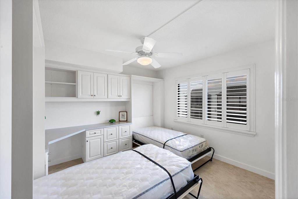 2810 North Beach Road, Unit D205 Englewood, FL 34223 - Photo 30 of 48 a bedroom with a bed dresser and a window