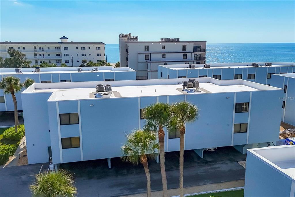 2810 North Beach Road, Unit D205 Englewood, FL 34223 - Photo 3 of 48 a roof deck with couches and potted plants