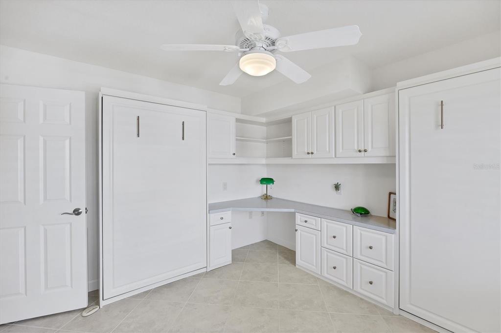 2810 North Beach Road, Unit D205 Englewood, FL 34223 - Photo 31 of 48 a kitchen with white cabinets and white appliances
