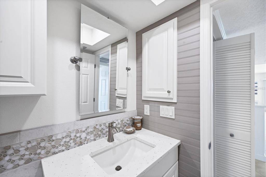 2810 North Beach Road, Unit D205 Englewood, FL 34223 - Photo 35 of 48 a bathroom with a sink and a mirror