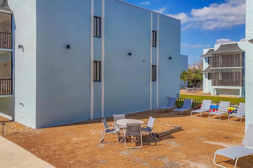 2810 North Beach Road, Unit D205 Englewood, FL 34223 - Photo 36 of 48 a view of a patio with a table and chairs and couches